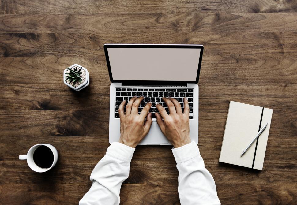 overhead-view-of-hands-typing-on-laptop